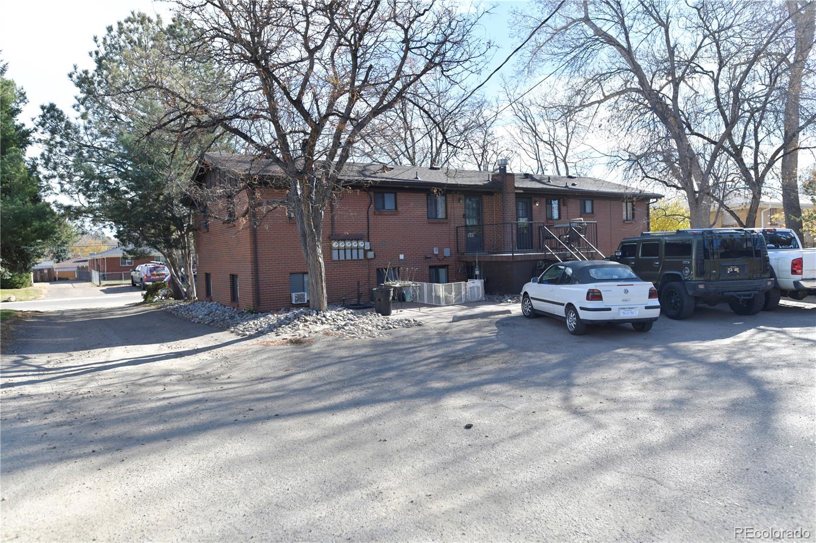 4563 Everett Street Wheat Ridge, CO 80033 - Photo 9 of 10 a car parked in front of a white house