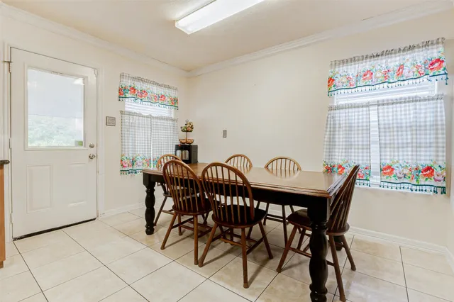a view of a kitchen with furniture and a potted plant