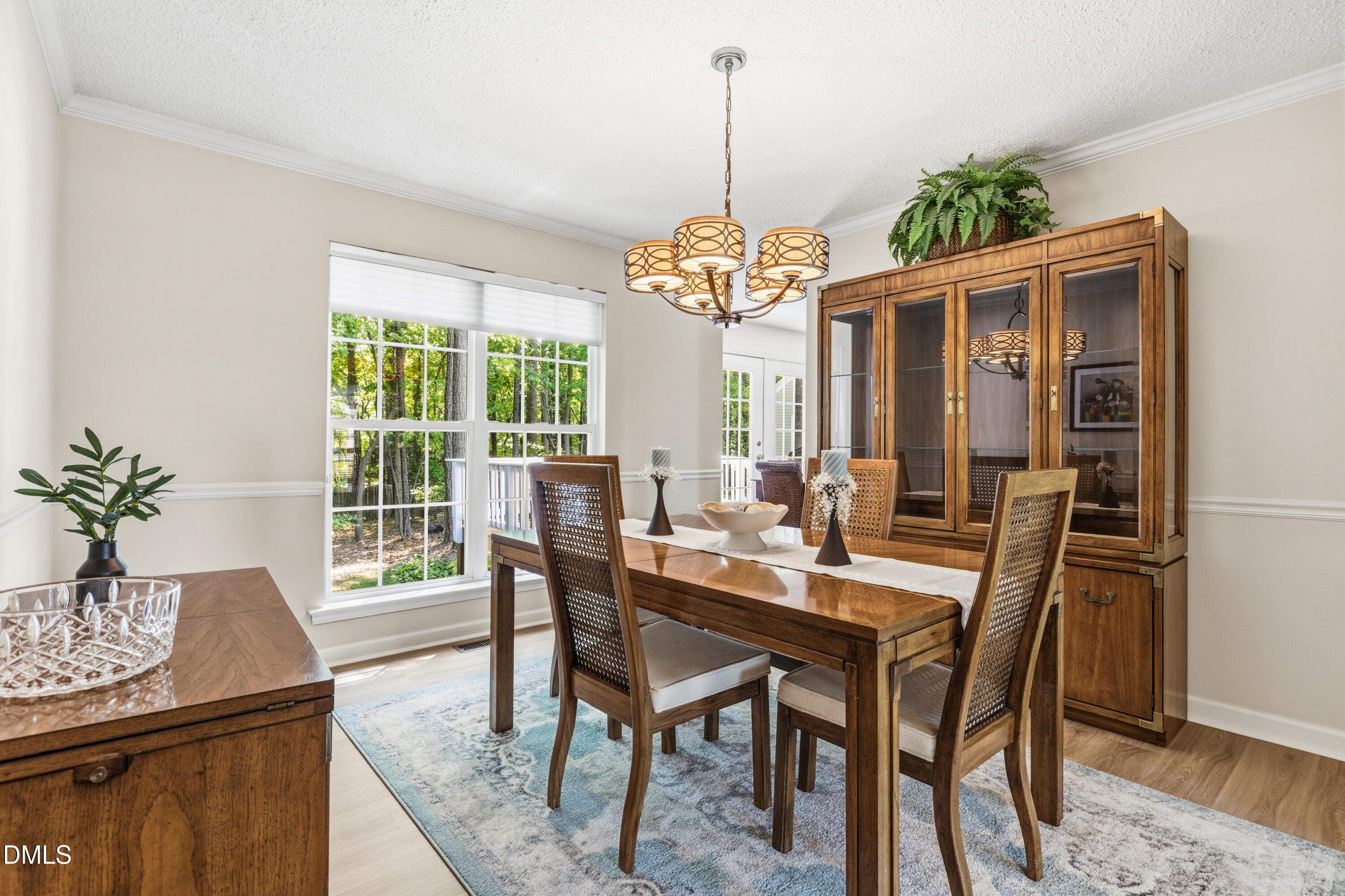 1211 Waterford Green Drive Apex, NC 27502 - Photo 15 of 53 a view of a dining room with furniture window and wooden floor