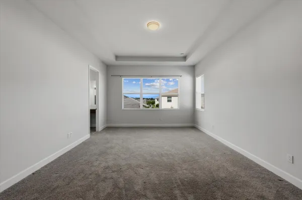 a view of a house with a big yard plants and large trees