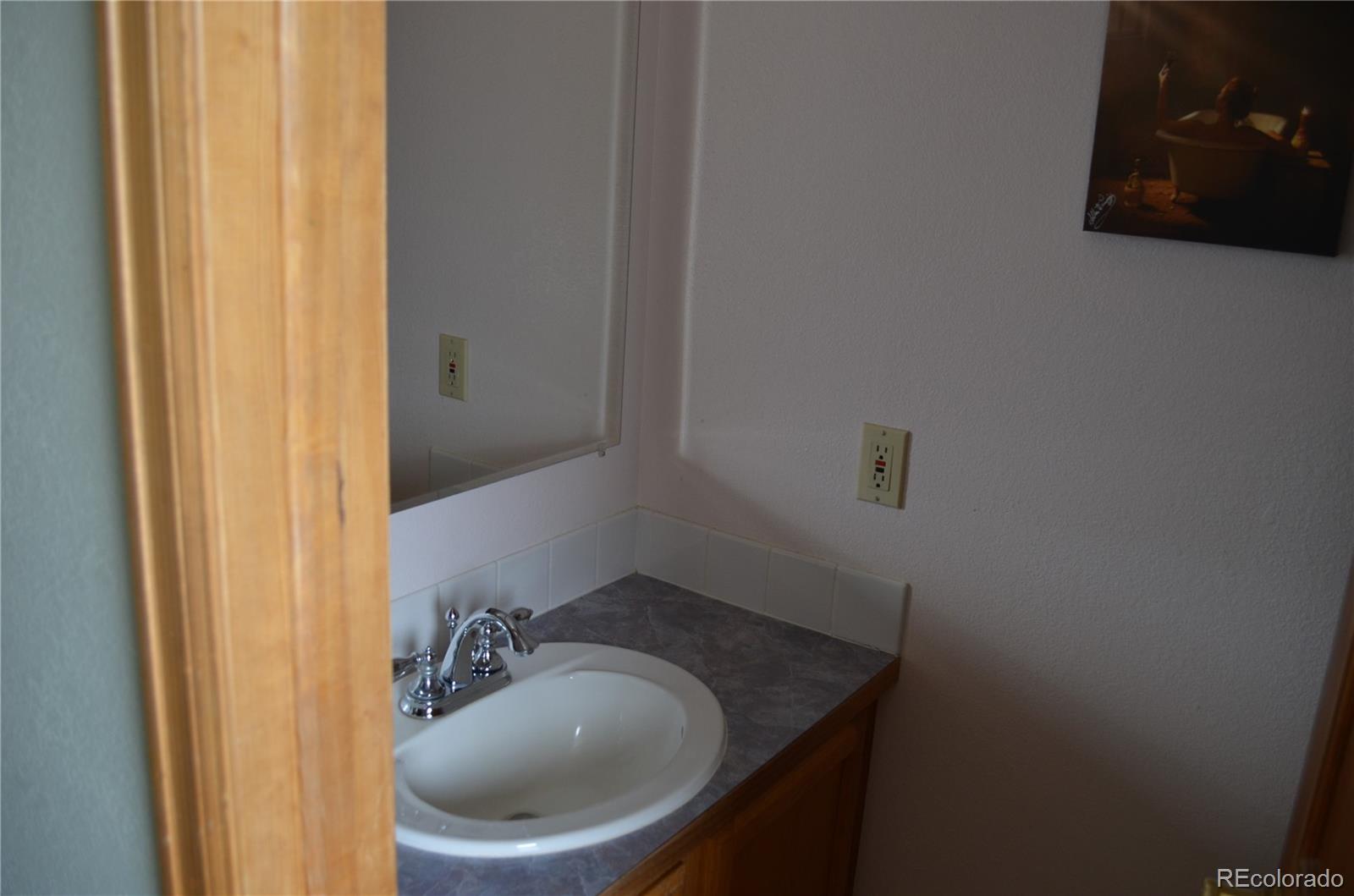 74500 East 136th Avenue Byers, CO 80103 - Photo 11 of 31 a bathroom with a sink and toilet
