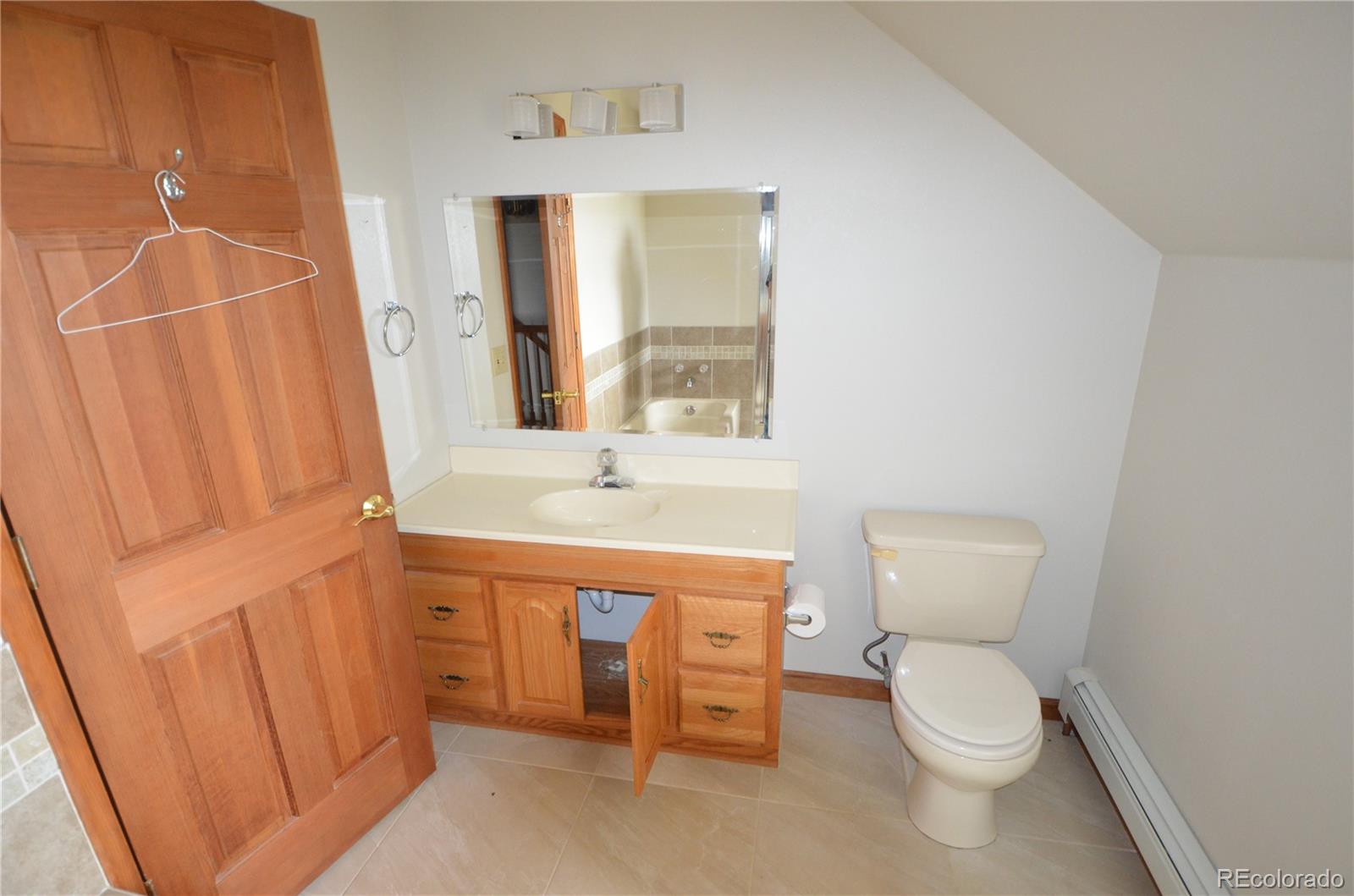 74500 East 136th Avenue Byers, CO 80103 - Photo 14 of 31 a bathroom with a toilet a sink and a bathtub