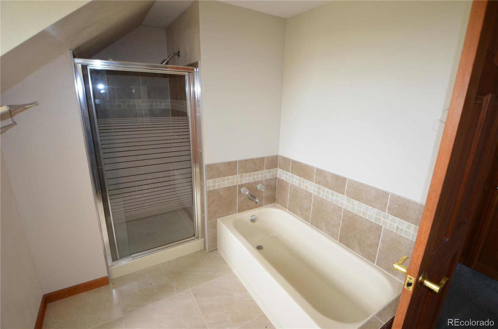 74500 East 136th Avenue Byers, CO 80103 - Photo 16 of 31 a bathroom with a bathtub and toilet