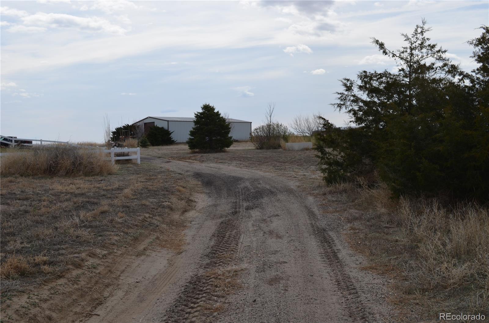 74500 East 136th Avenue Byers, CO 80103 - Photo 24 of 31 a view of a dry yard with wooden fence