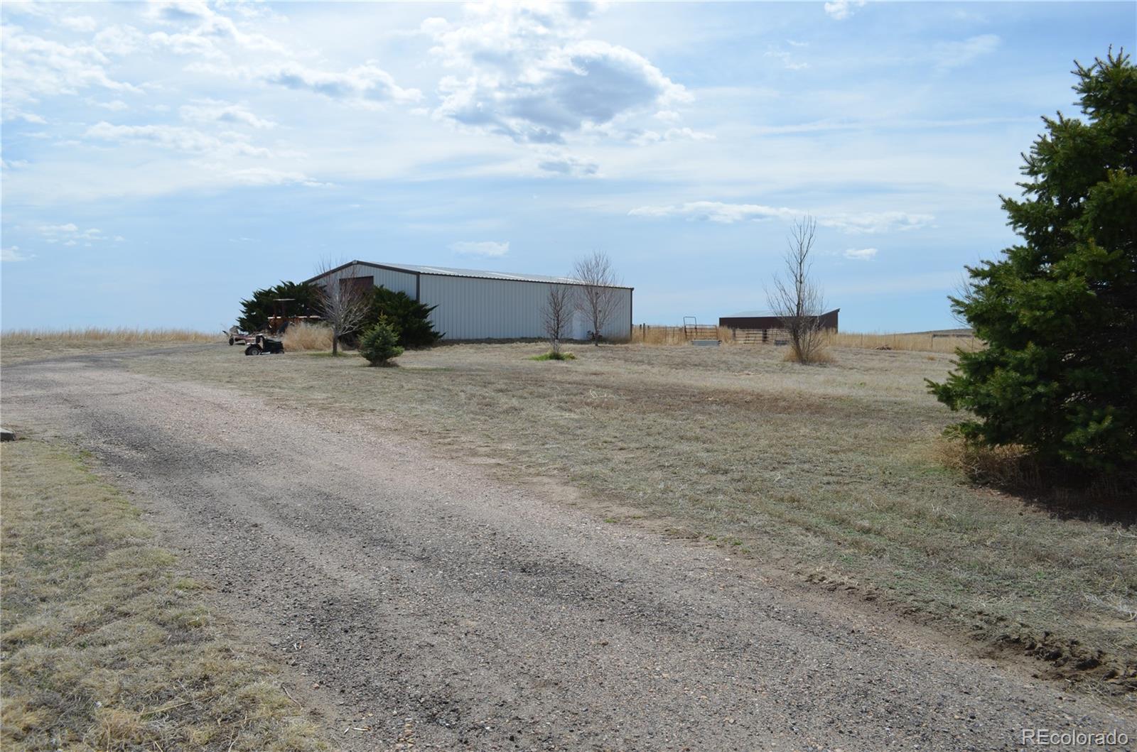 74500 East 136th Avenue Byers, CO 80103 - Photo 25 of 31 a view of a dry yard with a car parked