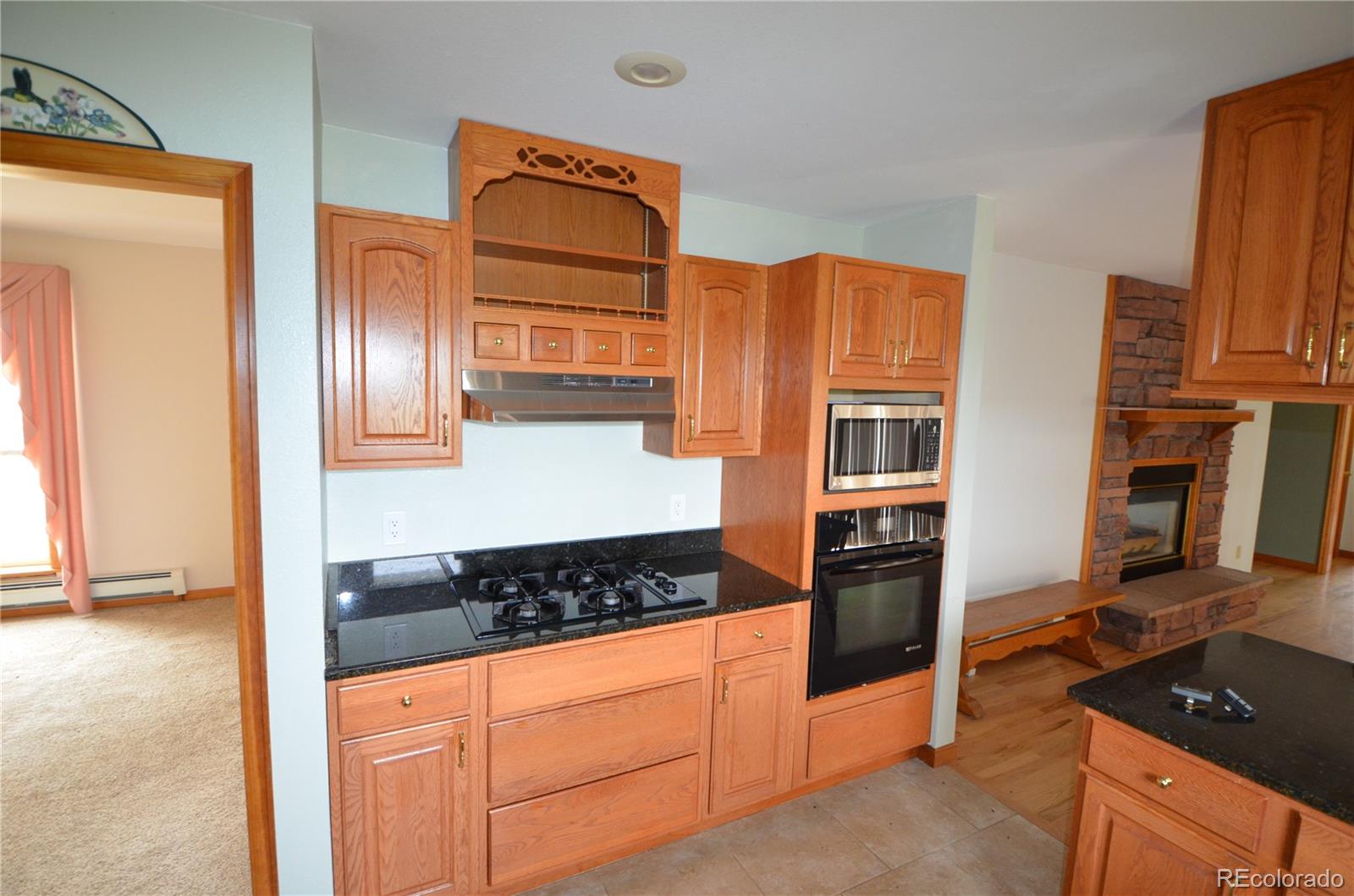 74500 East 136th Avenue Byers, CO 80103 - Photo 6 of 31 a kitchen with stainless steel appliances granite countertop a stove and a refrigerator