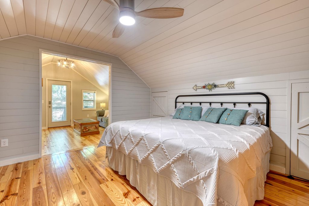 919 New Hope Road Morganton, GA 30560 - Photo 34 of 52 a bedroom with a bed and wooden floor