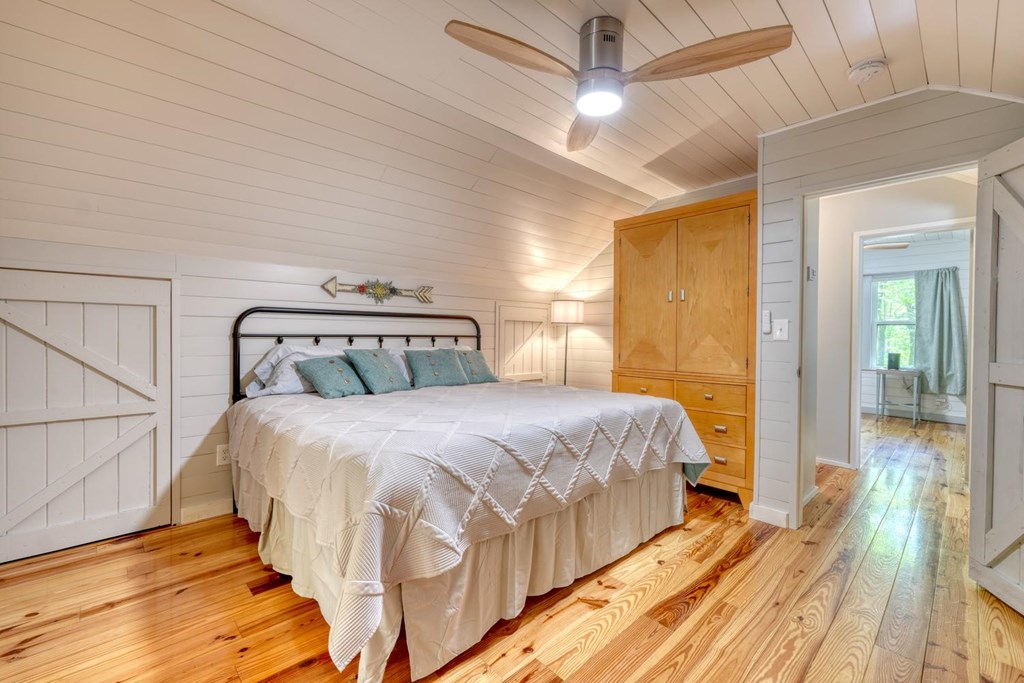 919 New Hope Road Morganton, GA 30560 - Photo 35 of 52 a bedroom with a bed and wooden floor