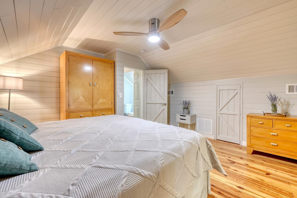 919 New Hope Road Morganton, GA 30560 - Photo 36 of 52 a bedroom with a bed and wooden floor
