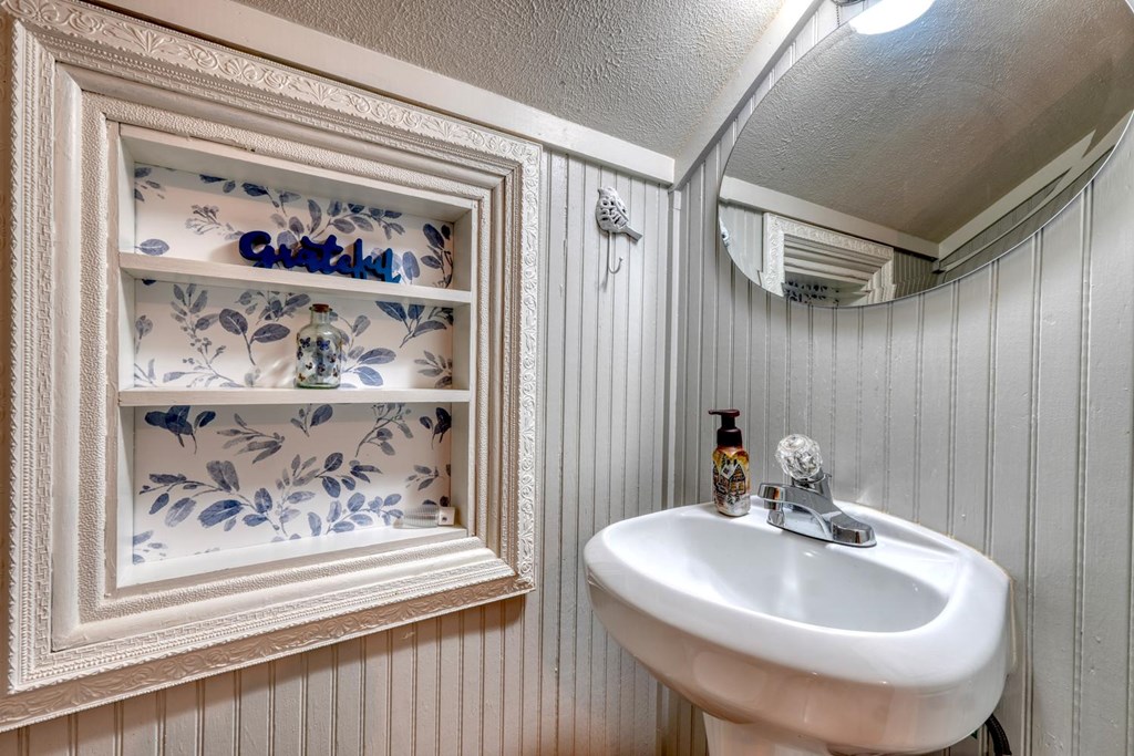 919 New Hope Road Morganton, GA 30560 - Photo 40 of 52 a bathroom with a sink and a mirror