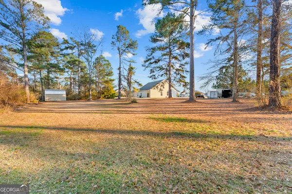 a view of backyard with large trees