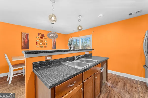 a kitchen with stainless steel appliances granite countertop a stove and a refrigerator