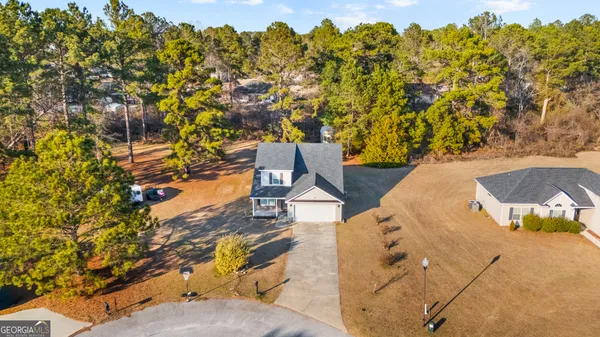 an aerial view of residential houses with outdoor space