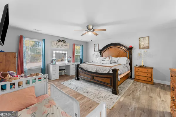 a bedroom with a bed and a dresser