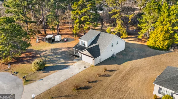 an aerial view of a house with a yard and garden