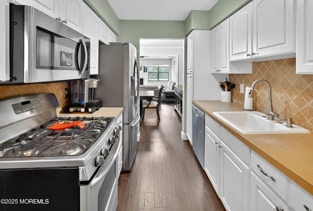 a kitchen with stainless steel appliances granite countertop a stove and a sink
