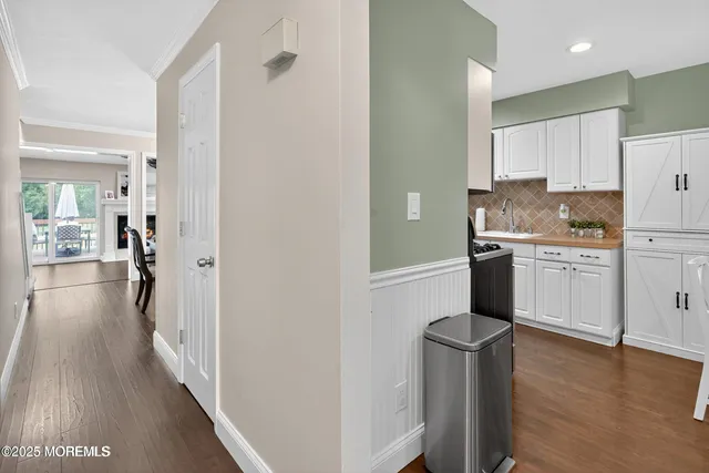 a kitchen with cabinets and wooden floor