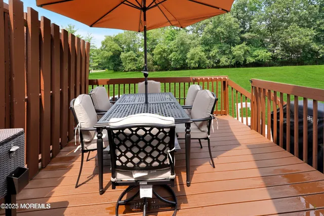 a view of balcony with furniture and umbrella