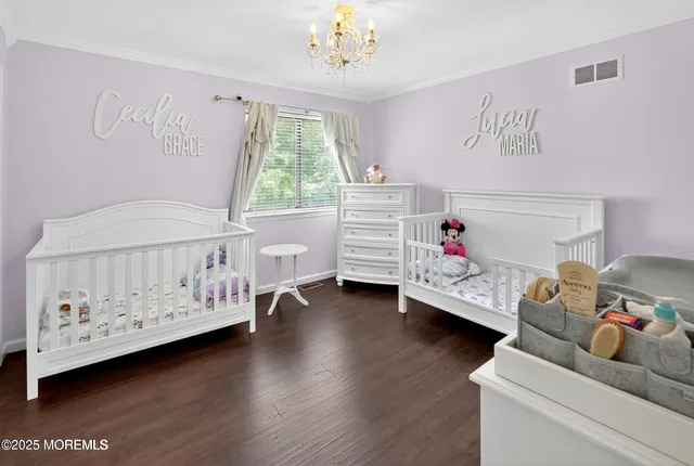 a bedroom with furniture and a large window