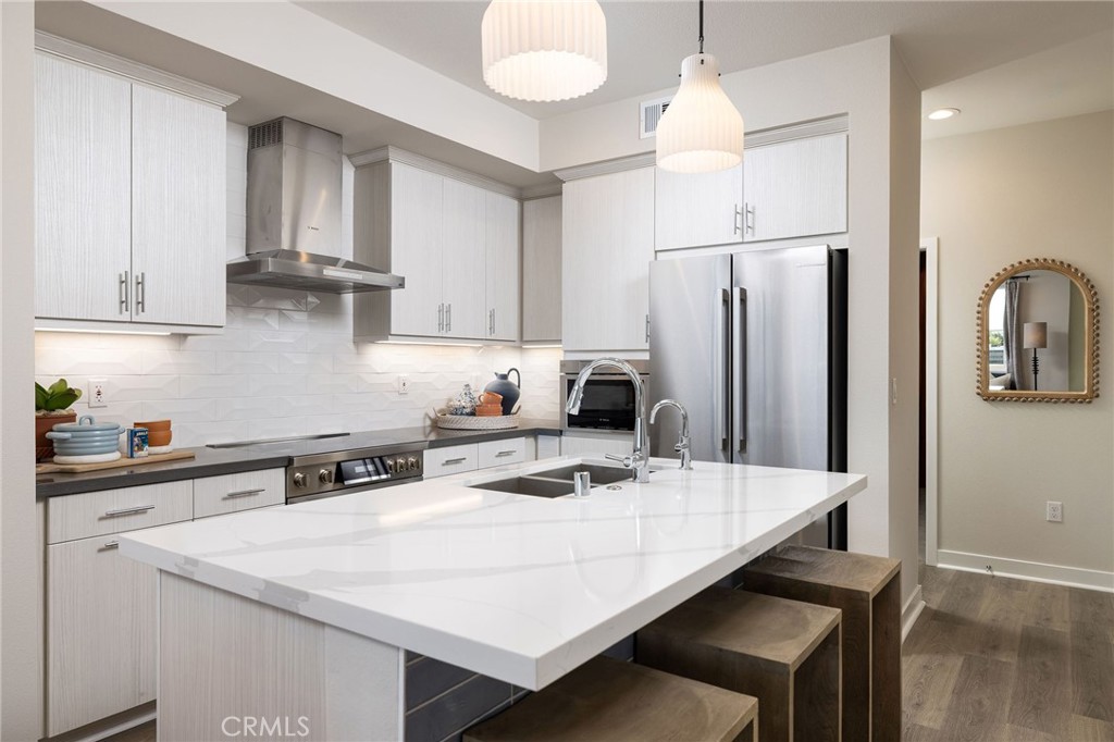 121 Towns Avenue Upland, CA 91786 - Photo 1 of 5 a kitchen with stainless steel appliances a white refrigerator a sink a stove and island