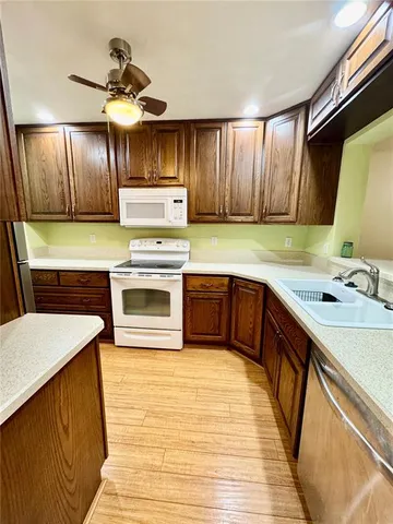 a kitchen with a sink stove and cabinets