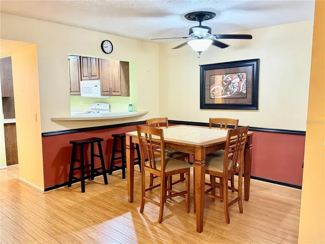 a view of a a dining room with furniture window and wooden floor