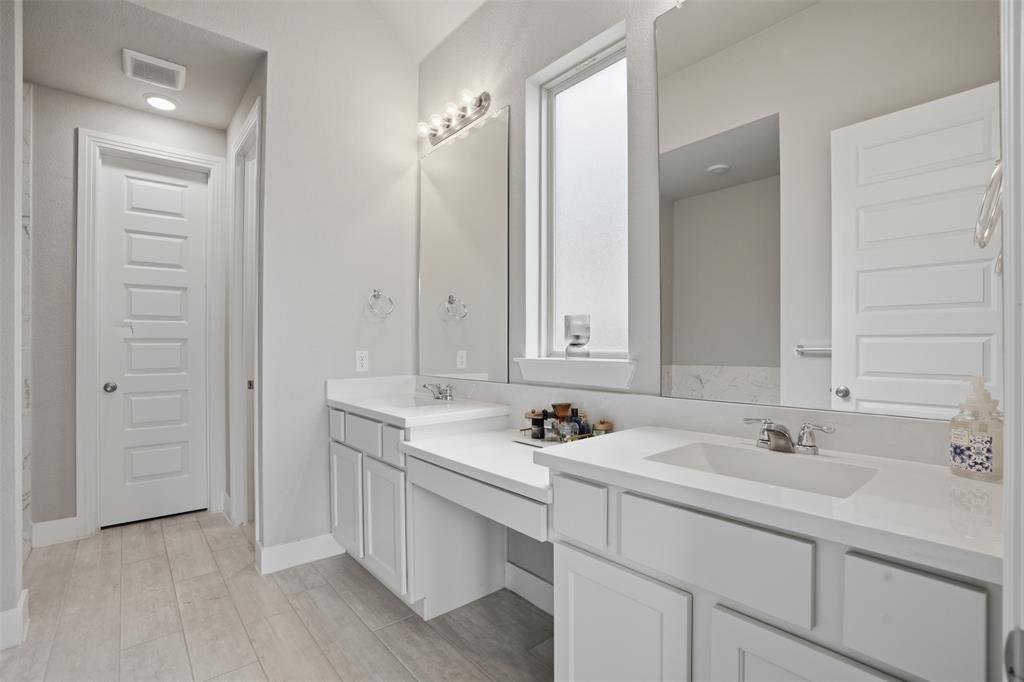 1429 Eclipse Road Aubrey, TX 76227 - Photo 14 of 37 Bathroom featuring a dual vanity with white cabinetry, a built-in dressing table, and a large mirror