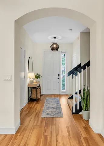 a view of an entryway with wooden floor and a potted plant