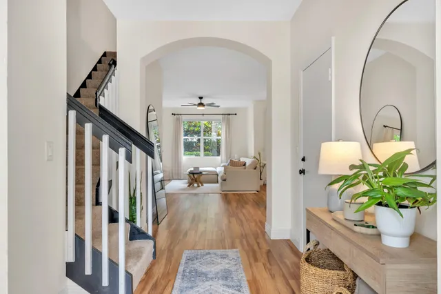a living room with furniture a window and a flat screen tv