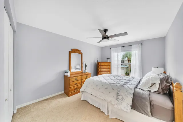 a bedroom with a bed and a large mirror