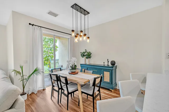 a dining room with furniture and wooden floor