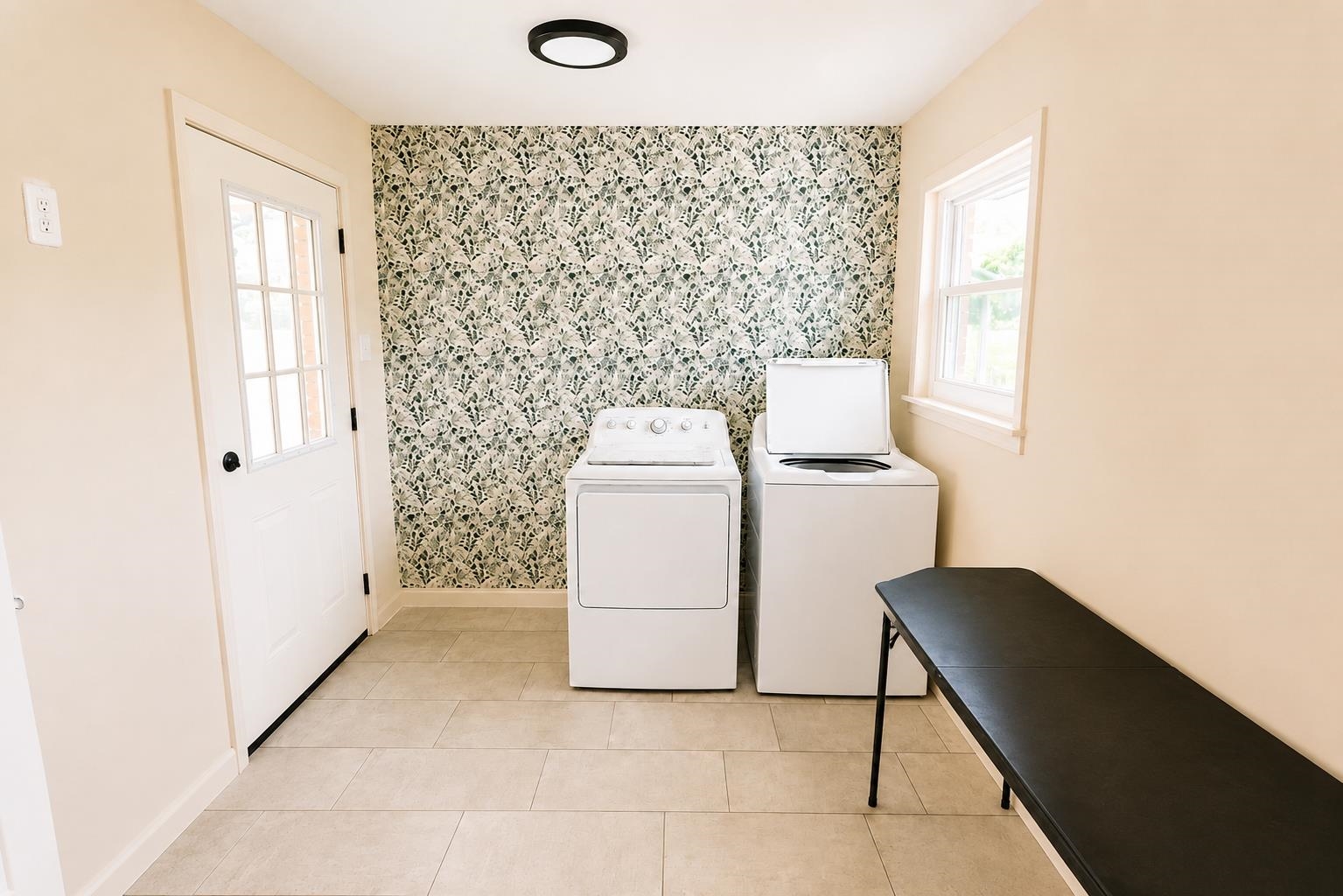 3226 19th Highway West Ripley, TN 38063 - Photo 17 of 18 Laundry area with light-toned rectangular floor tiles, a window providing natural light, and a patterned accent wall