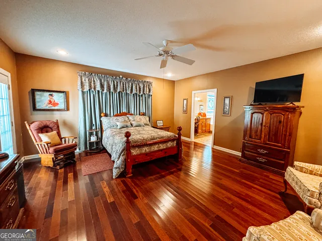 a bedroom with furniture and wooden floor