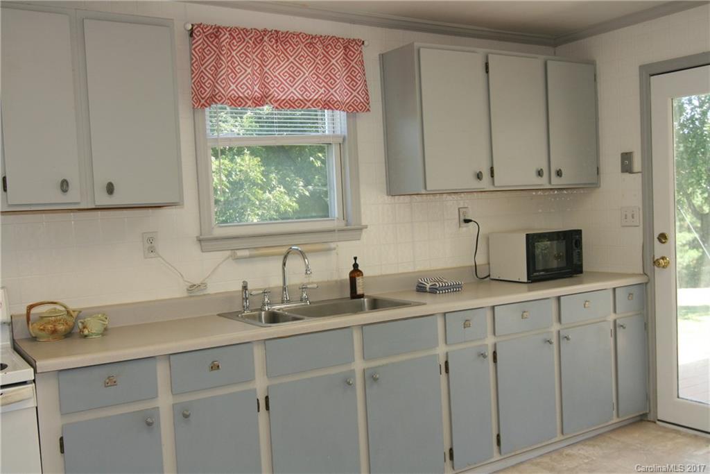 7540 Jones Road Salisbury, NC 28147 - Photo 10 of 24 a kitchen with white cabinets and a window