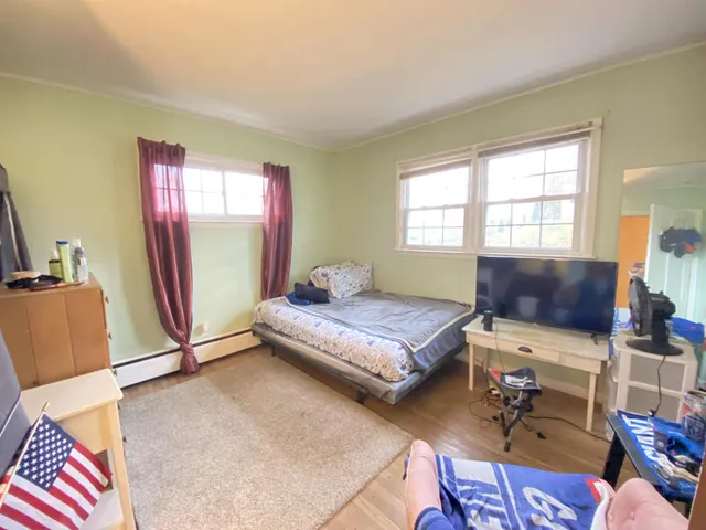 a bedroom with furniture and a window