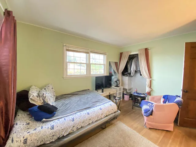 a bedroom with a bed and window