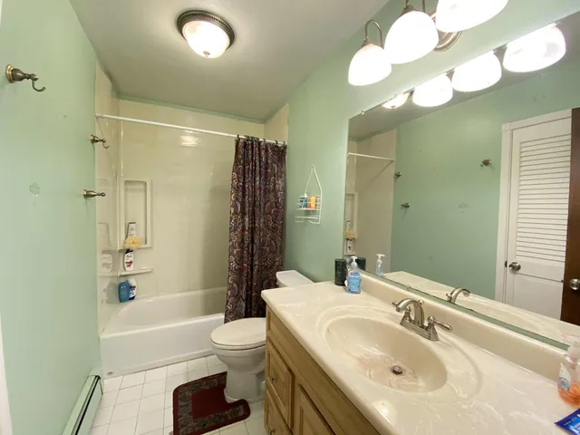 a bathroom with a sink toilet tub and shower