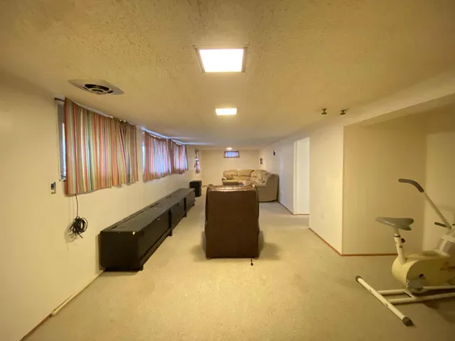 a living room with a table and gym equipment