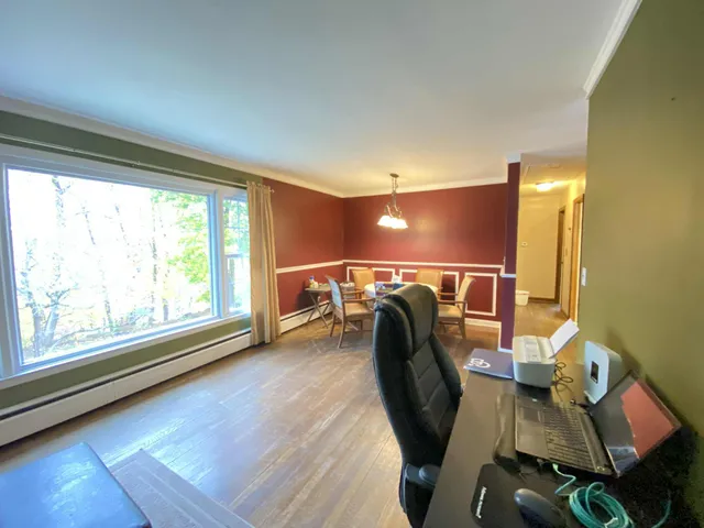 a view of a room with gym equipment and a large window