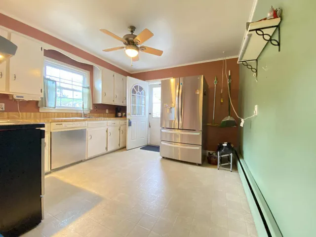 a view of a kitchen with microwave and cabinets