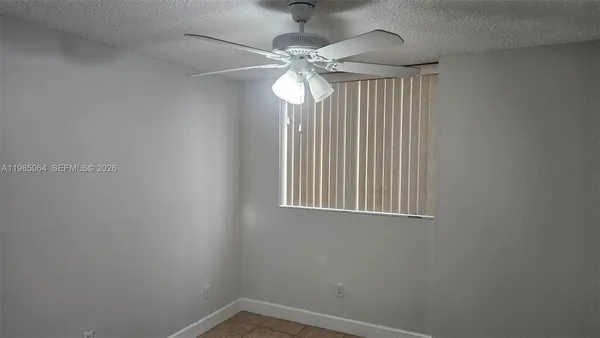 a view of a chandelier fan and a window