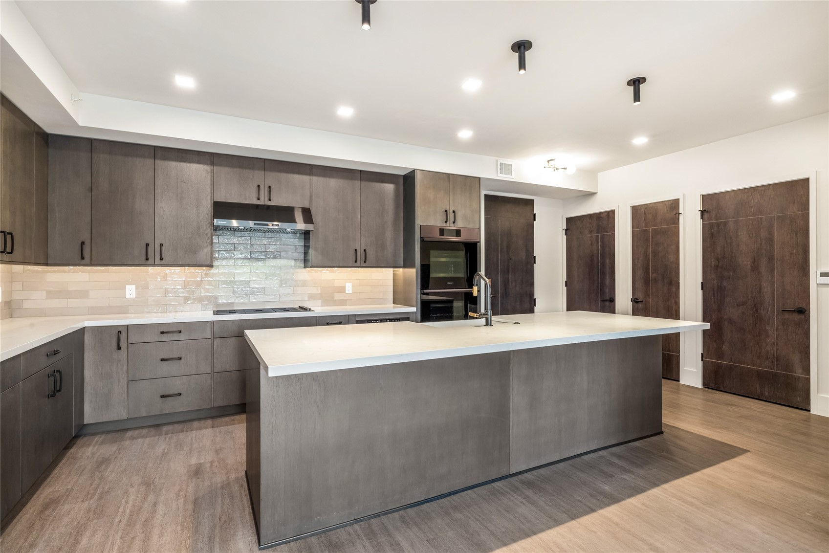 80 West Main Street, Unit 306 Frisco, CO 80443 - Photo 1 of 43 a large kitchen with stainless steel appliances lots of counter space and wooden floor
