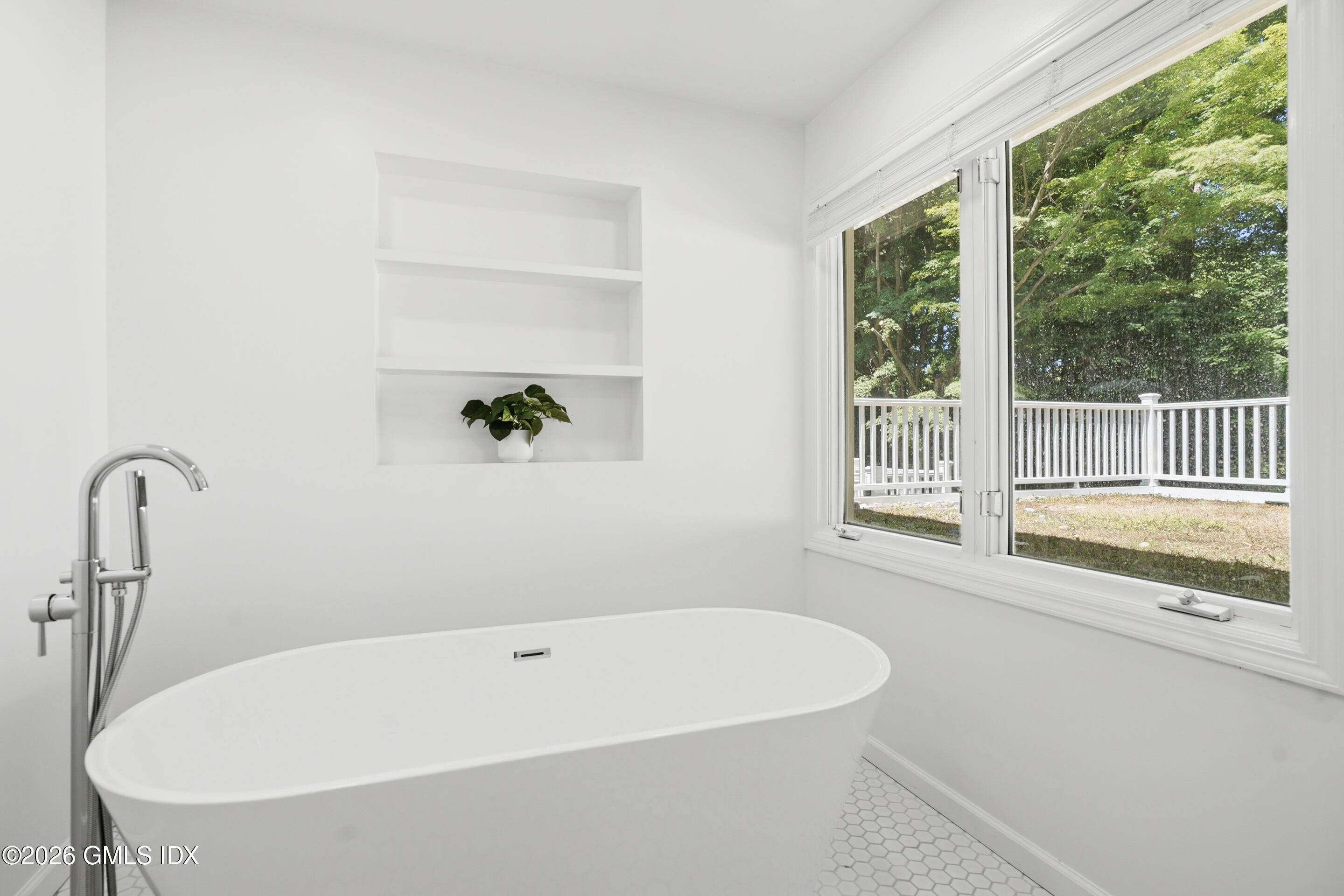 33 Sachem Road Greenwich, CT 06830 - Photo 13 of 35 a white bath tub sitting in a bathroom next to a window