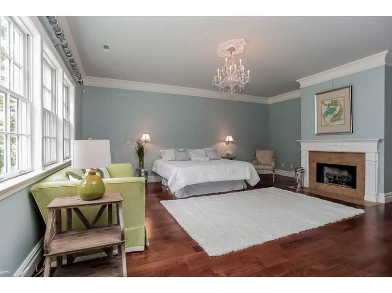 35 Hillsley Road Darien, CT 06820 - Photo 17 of 25 a bedroom with a bed and a chandelier