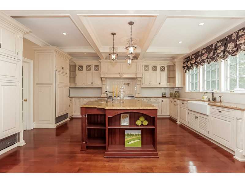 35 Hillsley Road Darien, CT 06820 - Photo 9 of 25 a large kitchen with stainless steel appliances granite countertop a stove a sink dishwasher and white cabinets with wooden floor