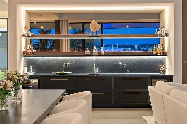 a living room with couches and kitchen view