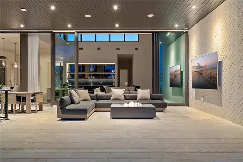 a view of a swimming pool with a lawn chairs under an umbrella