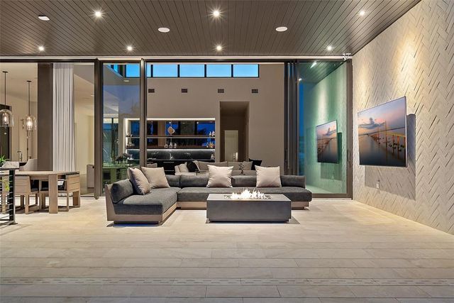 a view of a swimming pool with a lawn chairs under an umbrella
