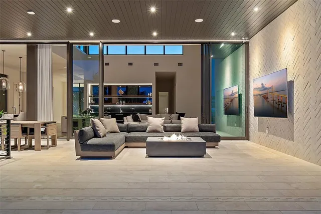 a view of a swimming pool with a lawn chairs under an umbrella