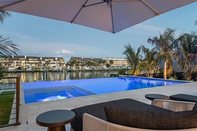 a view of swimming pool with outdoor seating and yard